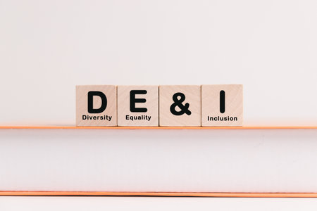 Business concept of diversity, equality, inclusion is symbol DEI written on wooden block,...