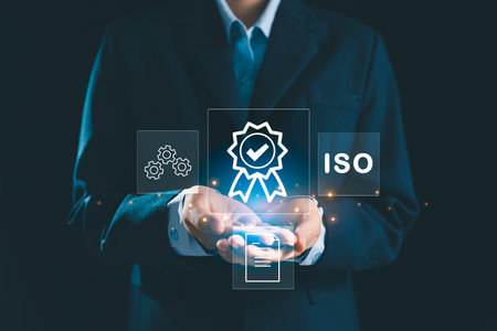 Person holding certificate icon represents concept of certification and standardization, business achieves ISO certified status quality assurance process in conformity with international standards.の写真素材