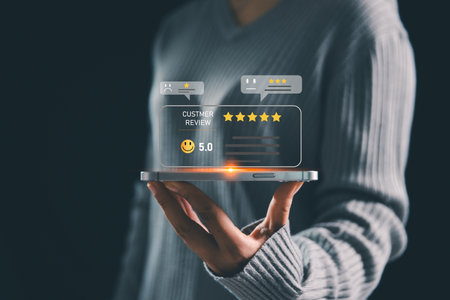 Businesswoman holding smartphone with floating customer review icons and star ratings, concept of online feedback, digital marketing, reputation management, customer satisfaction.の写真素材