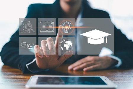 Concept of online education and digital learning is illustrated by hand using laptop, surrounded by icons such diploma, brain, target-symbolizing ideal e-learning platforms on education, developmentの写真素材