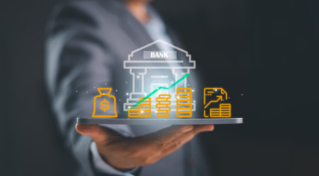 A business professional presenting digital banking icons with money growth, financial data and investment symbols, illustrating modern finance, economic strategy and online banking innovation.の写真素材