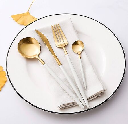 Golden spoon set on the plate.の写真素材