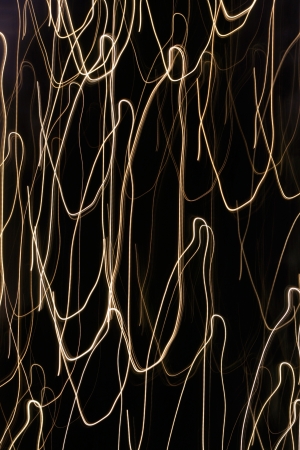 Moving holiday lights create an abstract pattern against a dark background の写真素材