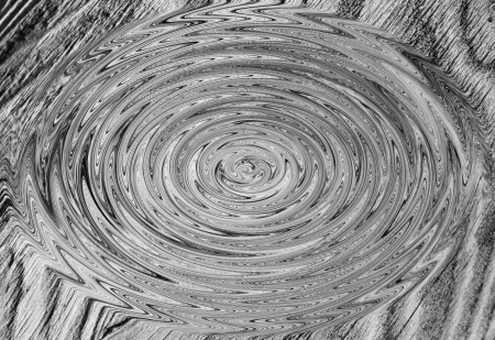 A swirled section of weathered wood forms an abstract, wavy pattern の写真素材