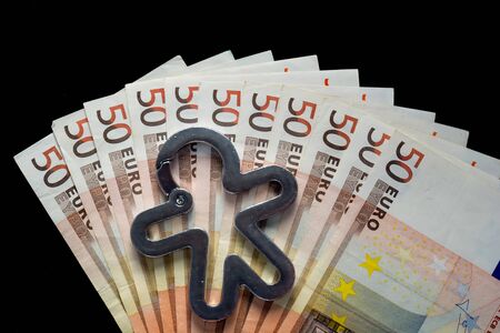 Charity concept. human silhouette on several 50 euro notes. view from above, black background
