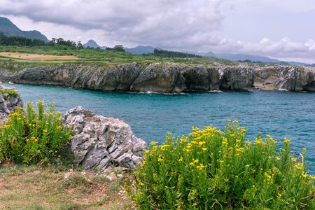 Line of rocks leading a view of a cliff in a cloudy day, location Bufones de Pria, Asturias, Spainの写真素材