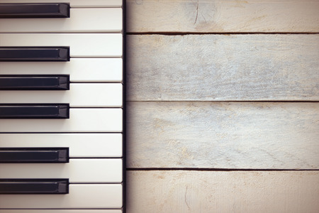 Inspirational background with a piano on a wooden table while composing.の写真素材