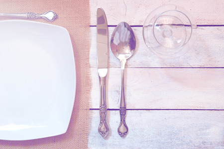 Some cutlery on a white wooden table. Empty copy space for Editor's text. Top view.の写真素材
