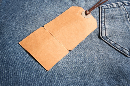 Cardboard label tied with leather to a blue jean, next to the back pocket. Empty space for copy editor's text.の写真素材