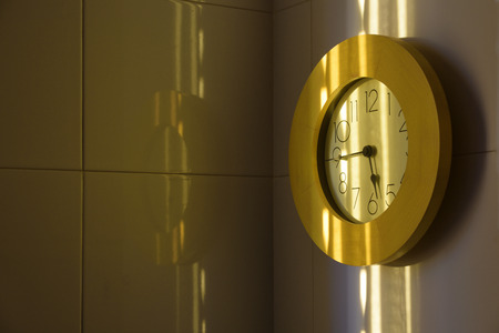 Yellow clock on a wall and naturally some light through the window. Empty space for copy editor's...