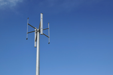 Wind power turbine in a power generation plant. Blue sky and empty copy space for Editor's content.の写真素材