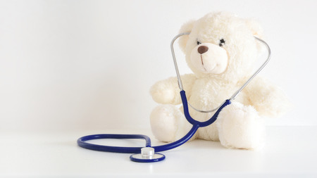 Teddy bear with a stethoscope. Pediatrician healthcare for children. Empty copy space for...