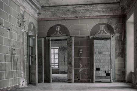 Two symmetrical windows in a scary and terrible room in an old abandoned building. Dirty and rusty...