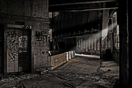 A ray of light hits an abandoned high-rise building with an elevator