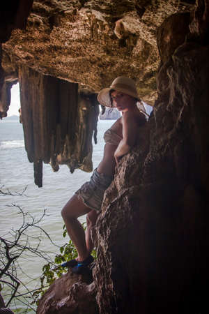 Girl in a cave near the sea in Thailandの写真素材