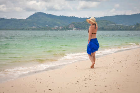 Girl on the seashore under the skyの写真素材