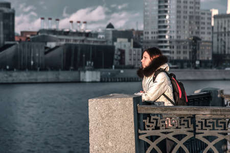 Girl on the embankment. Moscow / Russian Federation / 07.03.2020の写真素材