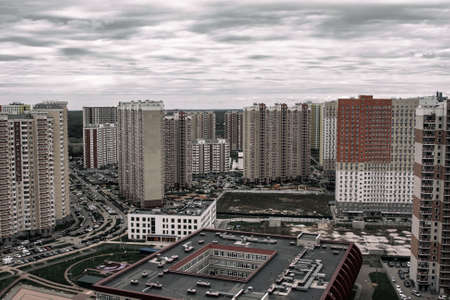 Many tall stone houses under a gloomy cloudy sky.