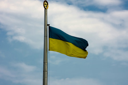 Yellow-blue Ukrainian flag is developing against the sky