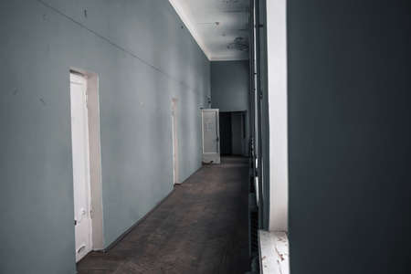 A corridor with doors in an old abandoned manor. Empty corridor.の写真素材