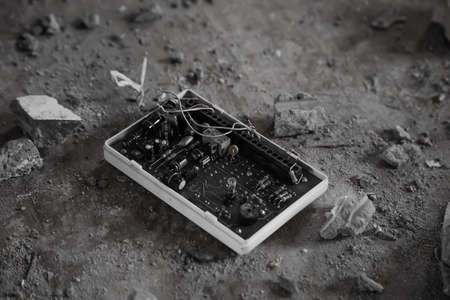 An old microcircuit lies on the floor in an old abandoned house.の写真素材