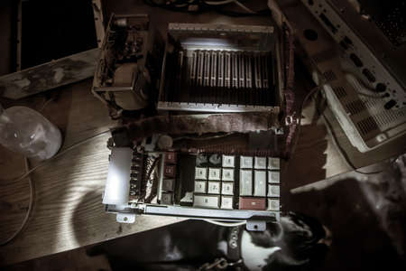 An old broken mechanism in an abandoned laboratory. Remains of equipment.