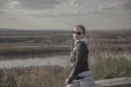 Beautiful girl in sunglasses against the backdrop of a natural landscape. Portrait of a girl....