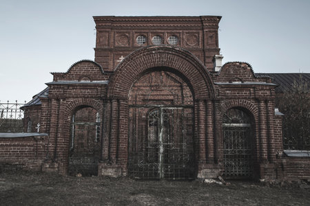 An old beautiful and scary abandoned church. Brick walls. Gloomy gothic atmosphere. Evening light.の写真素材