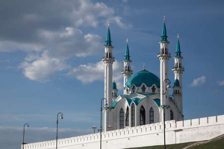 Ancient beautiful mosque against the blue sky. A large mosque with four minarets. Crescents at the...