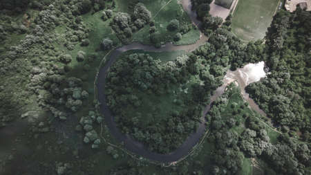 A beautiful bend of the river from above. Green Park. Beautiful trees. The sun's rays are reflected from the ground and water.の写真素材