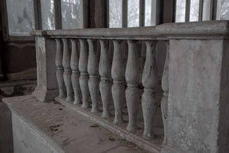 Beautiful curly columns in an old abandoned manor house. Ancient architecture. Stone columns.