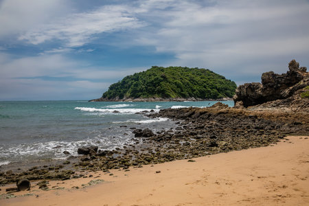 Beautiful tropical beach with turquoise ocean water and rocks.の写真素材