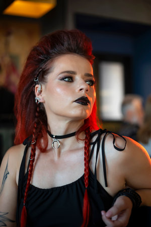 Portrait of a girl with red hair in a black dress
