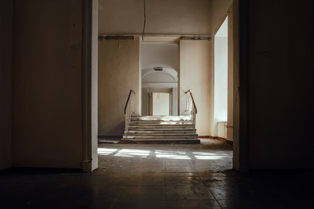 Interior of an old building with stairs and light from the windowの写真素材
