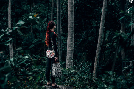 Woman walking in the forest. Travel concept.の写真素材