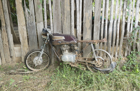An old cafe racer style motorcycle against the abandon shed.の写真素材