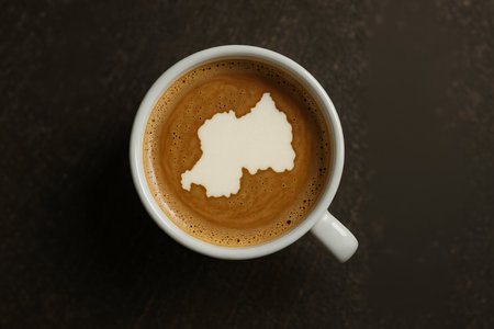 Cup of coffee with milk foam and map of Belgium on wooden backgroundの素材