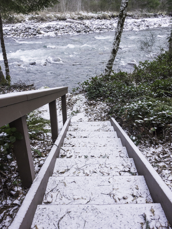 Stairway down to river covered in snowの写真素材