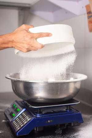 Preparing pizza. Applying the tomato sauce. italian restaurantの写真素材