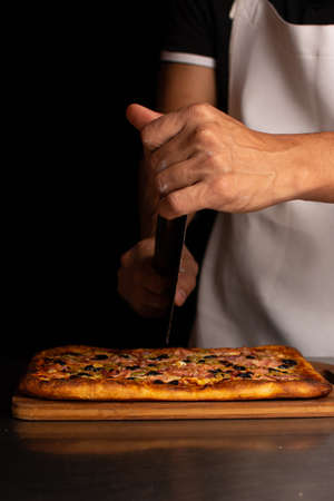 Preparing pizza. Applying the tomato sauce. italian restaurantの写真素材