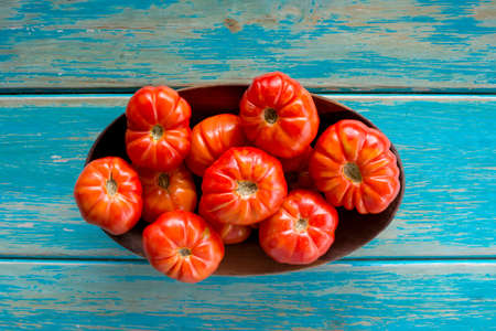 Fresh tomatoes on wooden tray. Big tomatoes.の写真素材