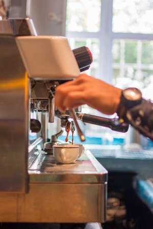 Preparing a cup of coffee in the machine.の写真素材