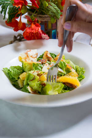 lettuce salad with nuts and fruitの写真素材