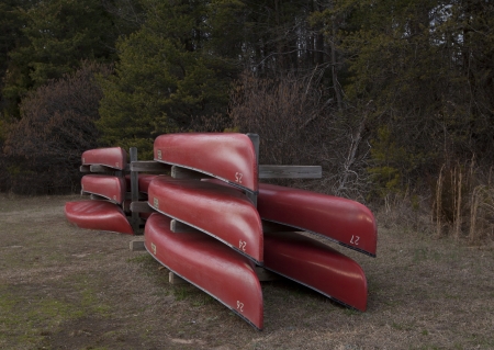 Stacked red canoesの写真素材