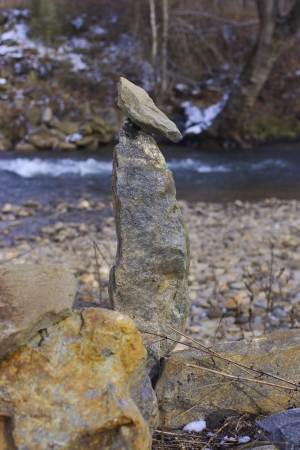A rock cairn by a riverの写真素材