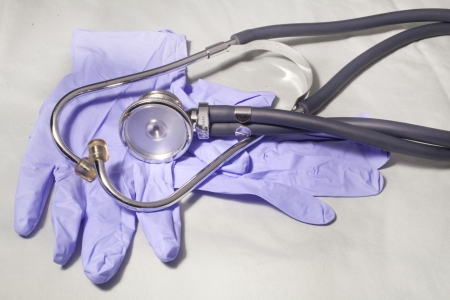 A stethoscope on blue latex gloves の写真素材