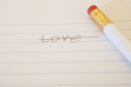 The word love written on paper and crossed out.の写真素材