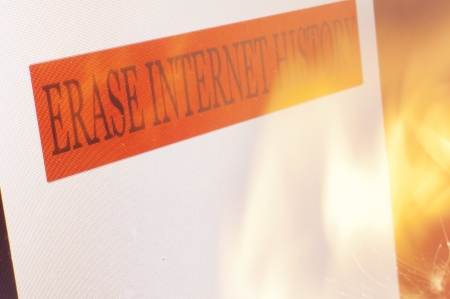 An Erase Internet History sign on a computer screen and flames from a  fire.の写真素材