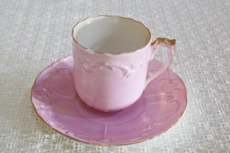 A vintage demitasse on a matching coasterの写真素材