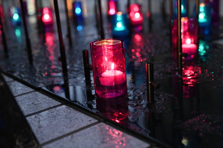 Candles in the cemetery on a rainy day. Selective focus.の写真素材